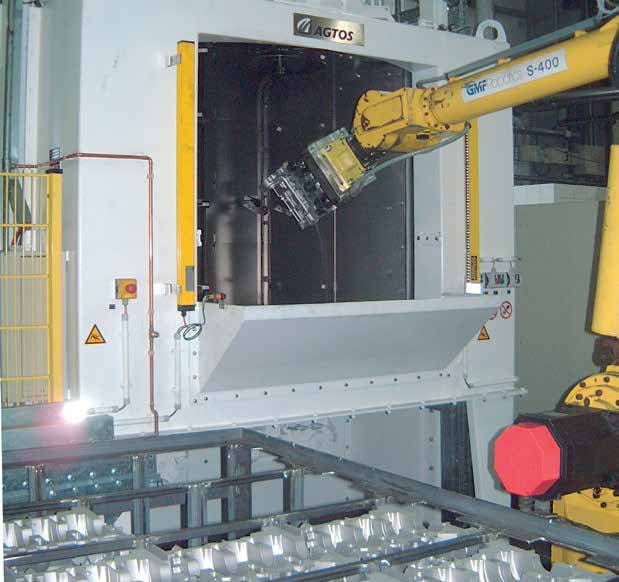 Rotary table blast machine with robot arm